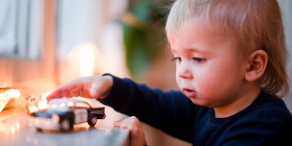 Little boy holding a toy car