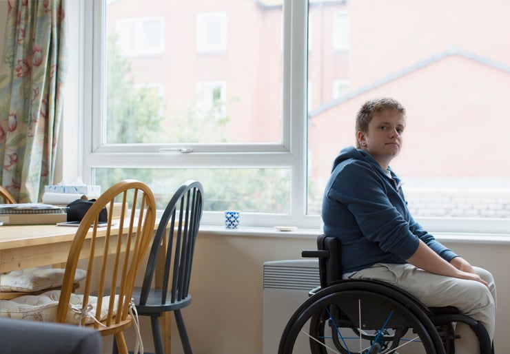 Person in wheelchair in kitchen at home