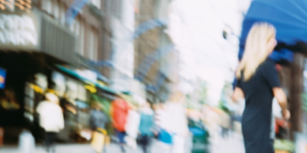 Street with people on the move. The image is blurry.