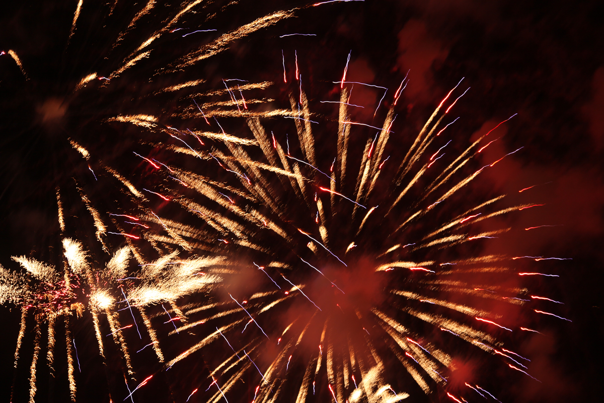 Fyrverkeri i gult og oransje mot sort himmel