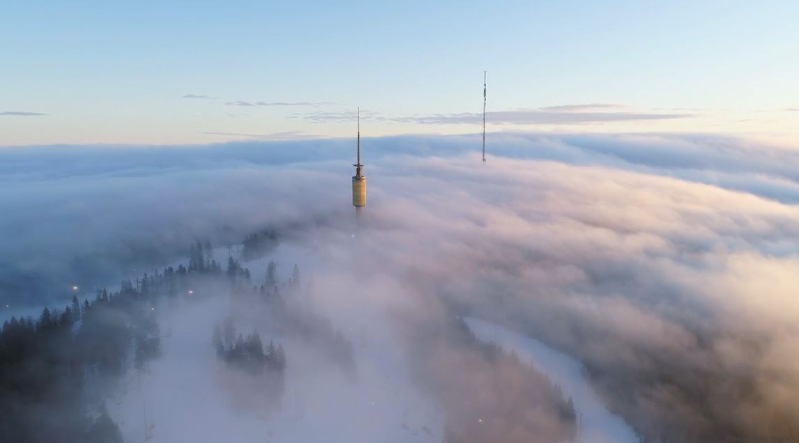 Drone image of antennas sticking up through the clouds