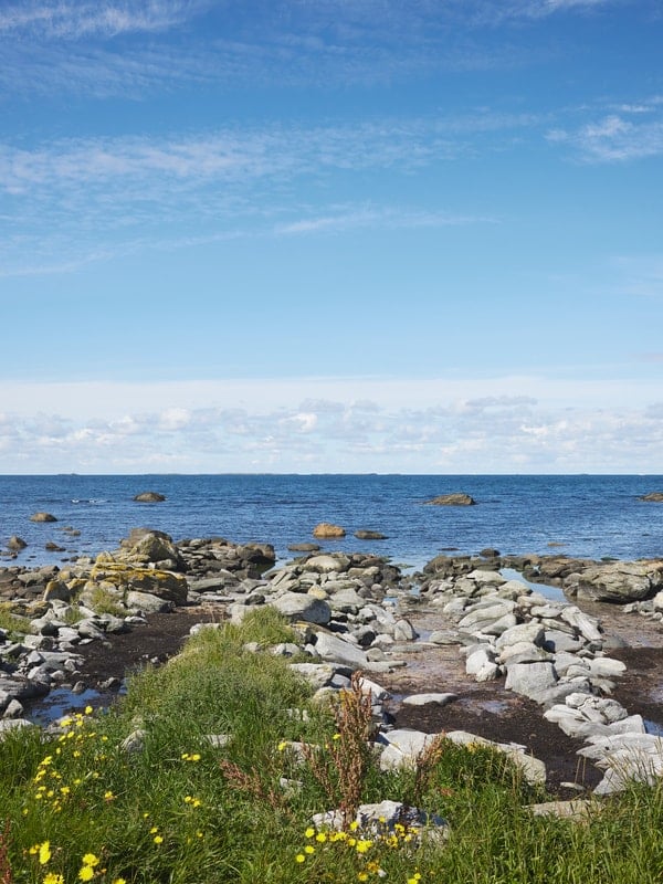 Norskekysten med steinete strand og utsikt over åpent hav