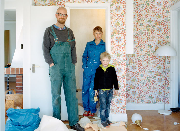 Family standing in a living room under renovation